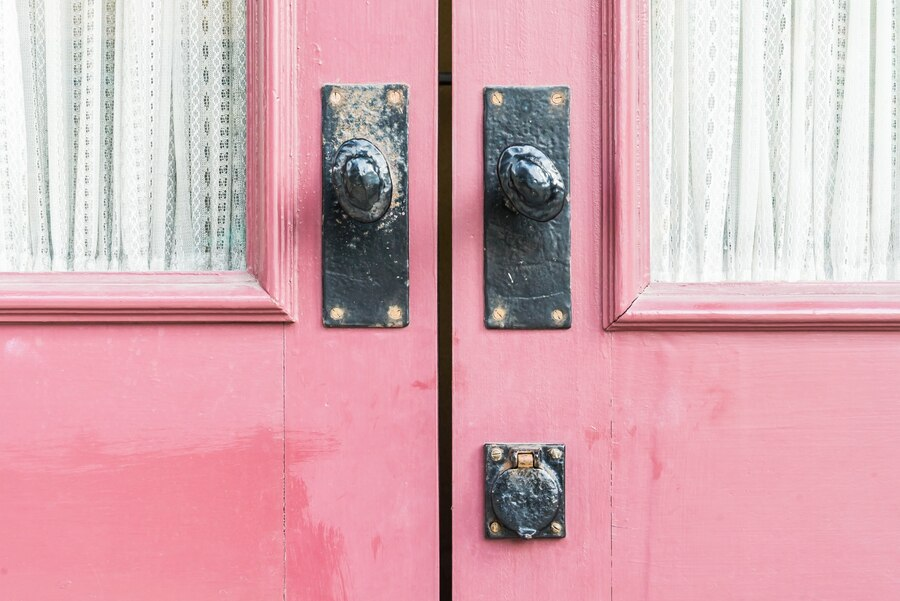 porta de madeira na cor rosa com fechadura vintage de ferro